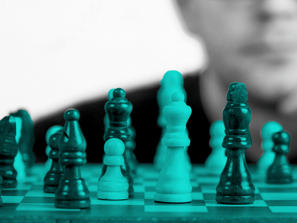 man gazing at a chess board